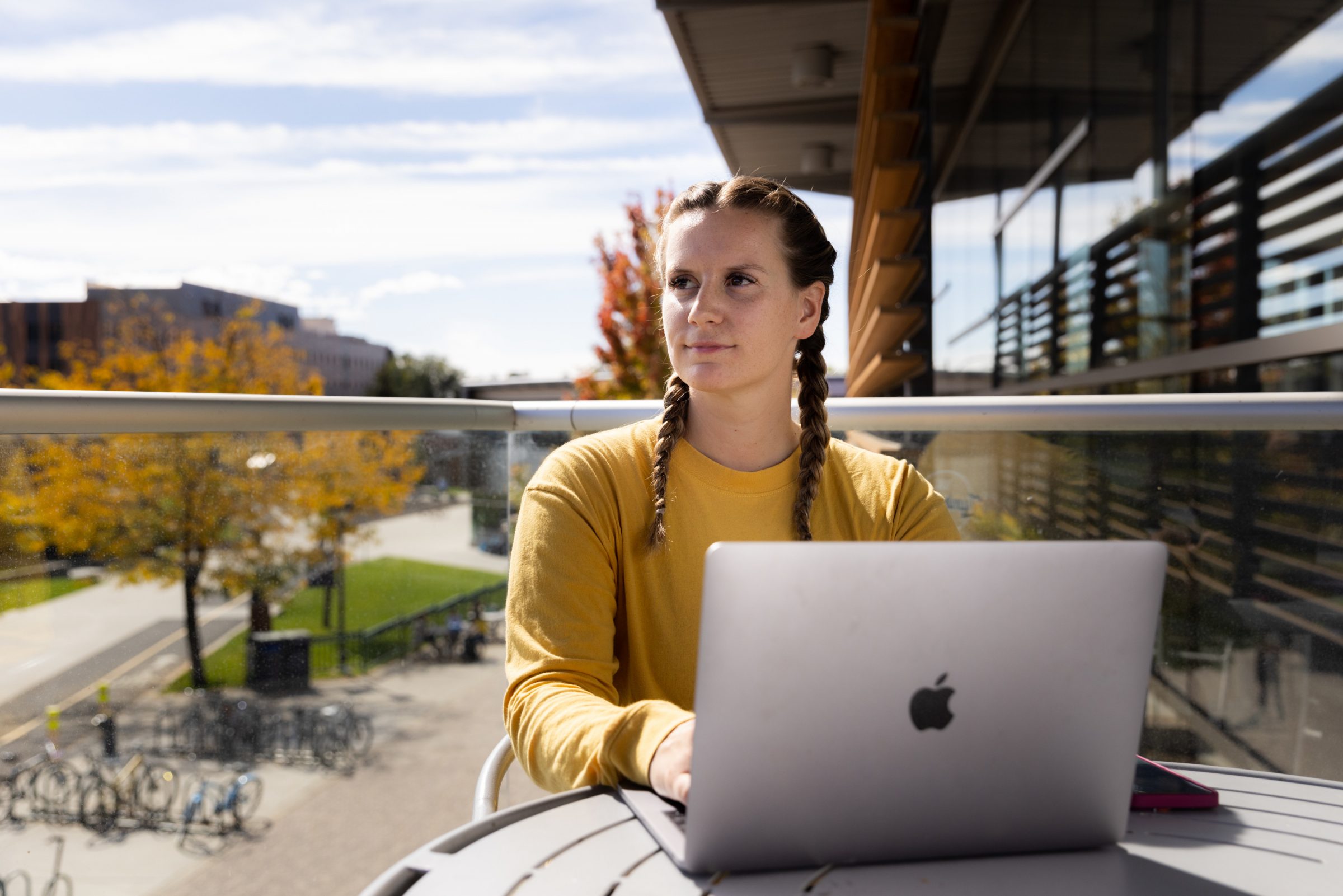 A student sits at a computer overlooking the N A U campus.