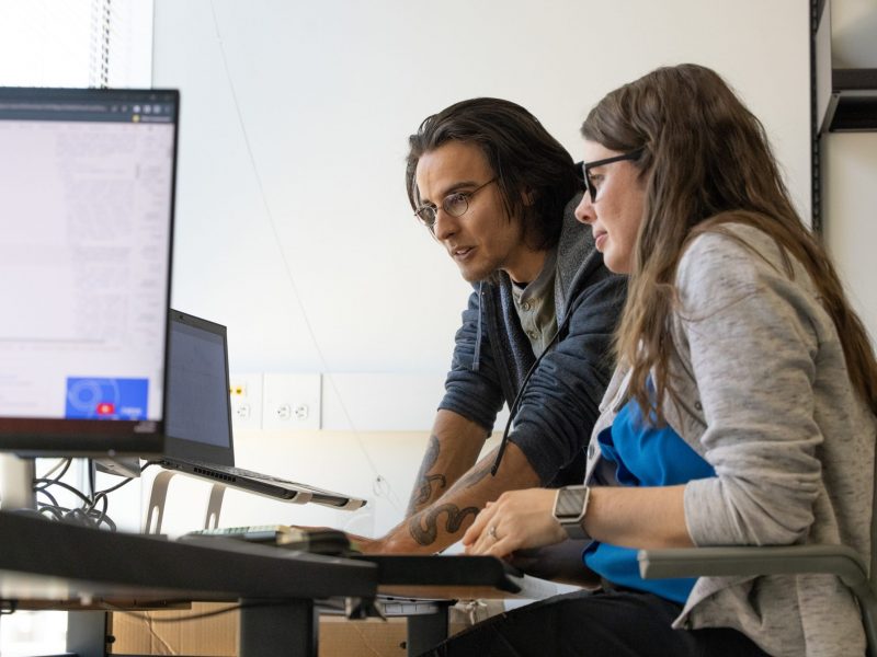 Professor Vigil Hayes working with student.