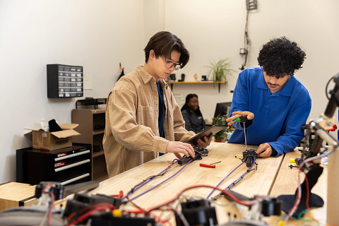 Students in a workshop using equipment.