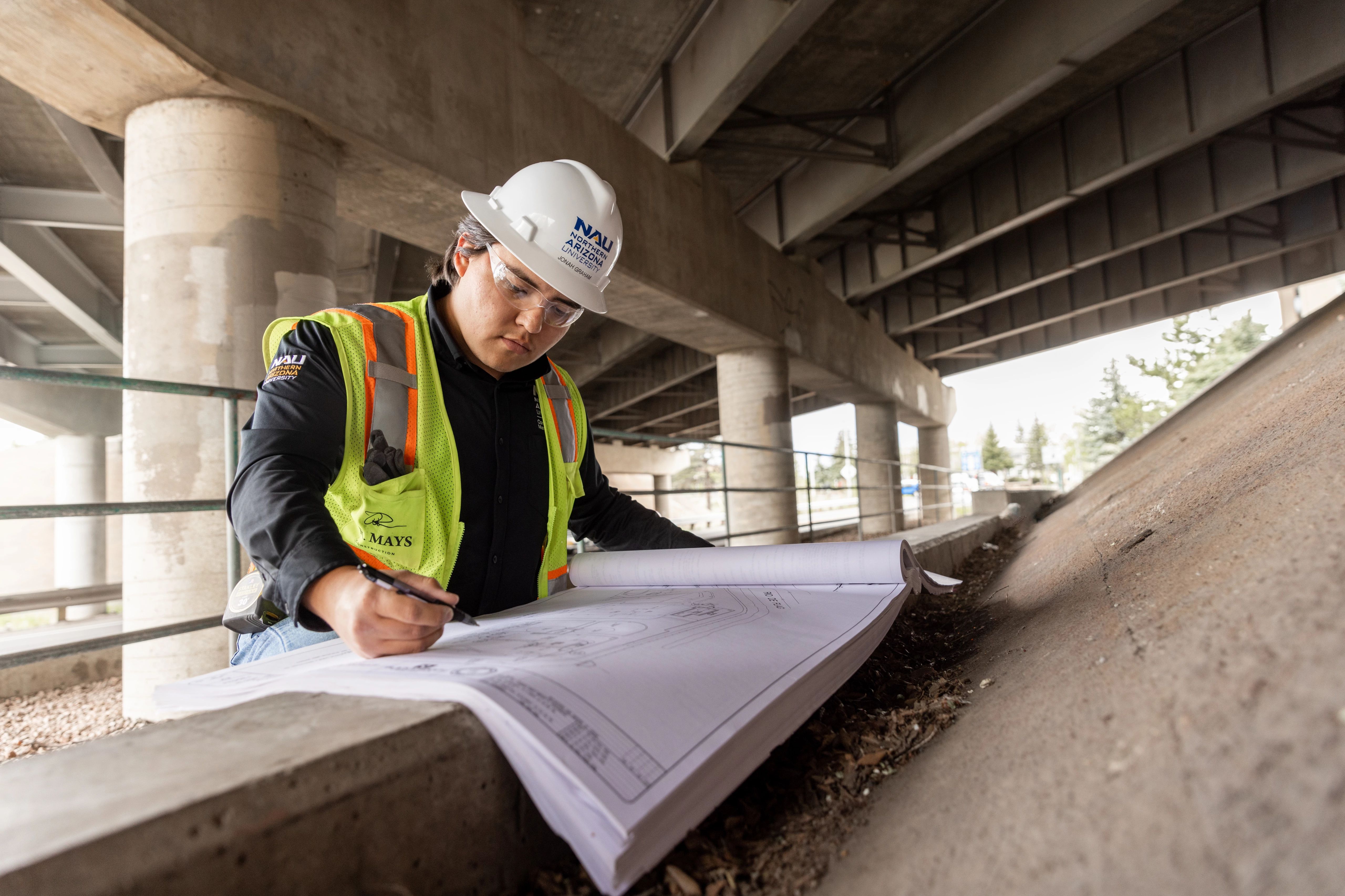 Construction worker reviewing blueprints.