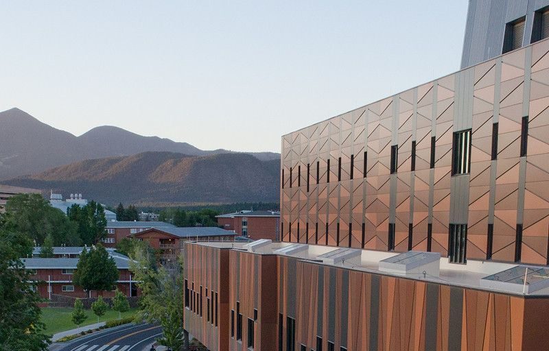 Photo of N A U campus and mountains at sunset.