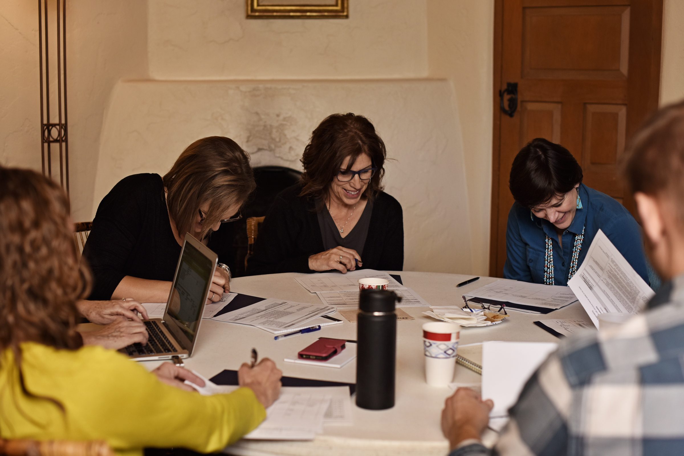 Bree Bullard, Suzie Martinez and Julie Baldwin work on a project during a retreat.