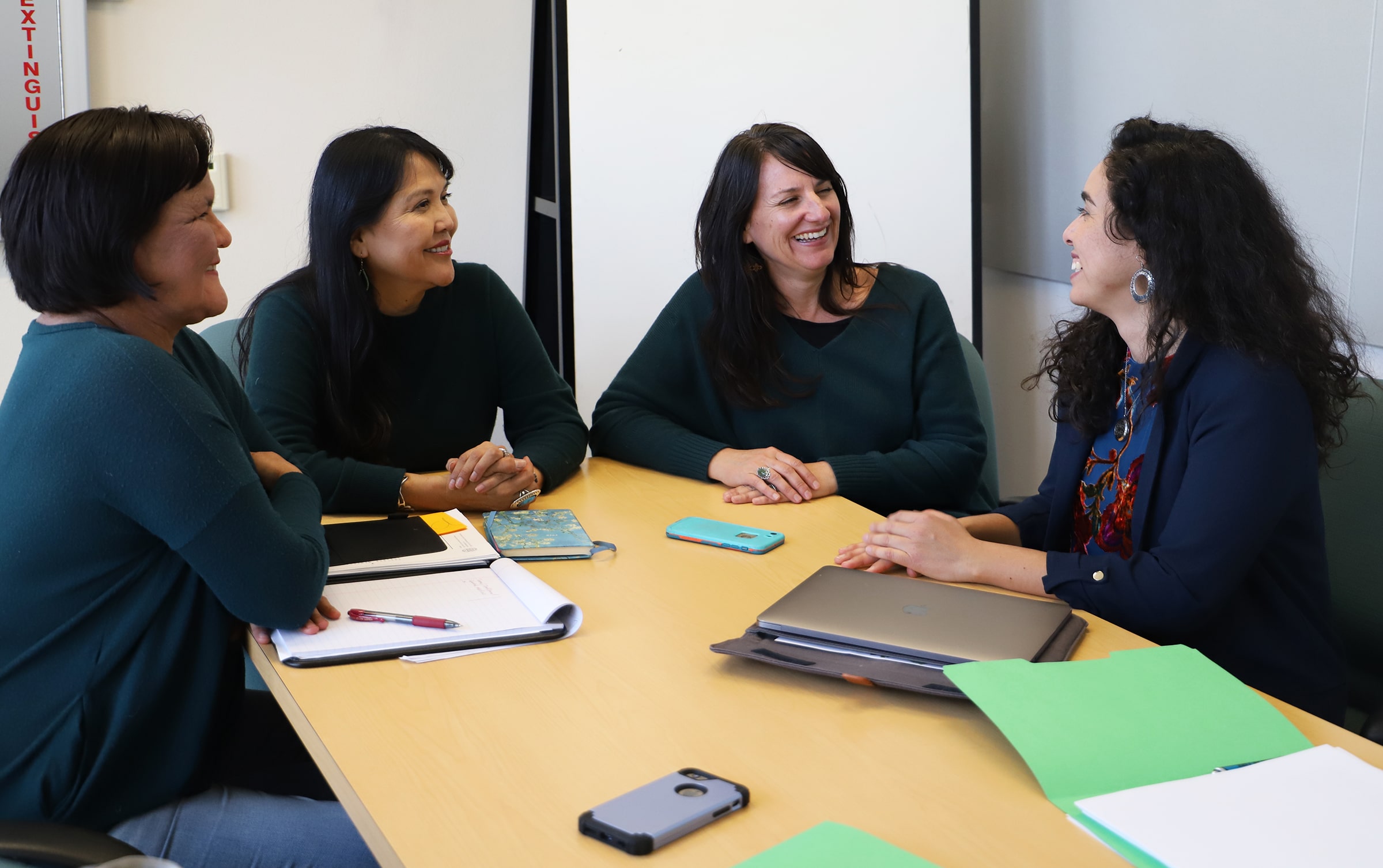 Four members having a Community Health Representatives meeting.