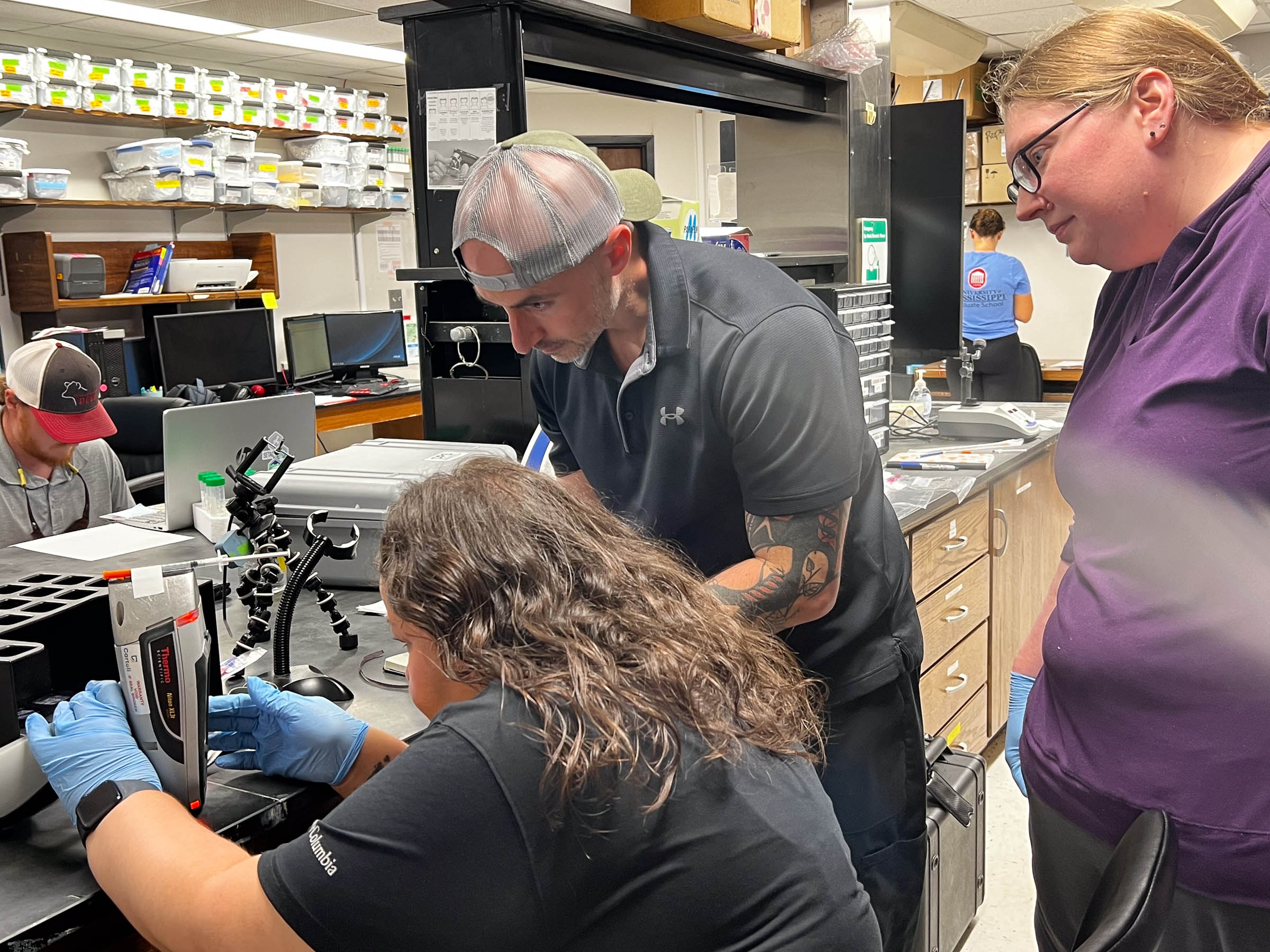 Goodluck operates a portable x-ray fluorescence device at the University of Mississippi.