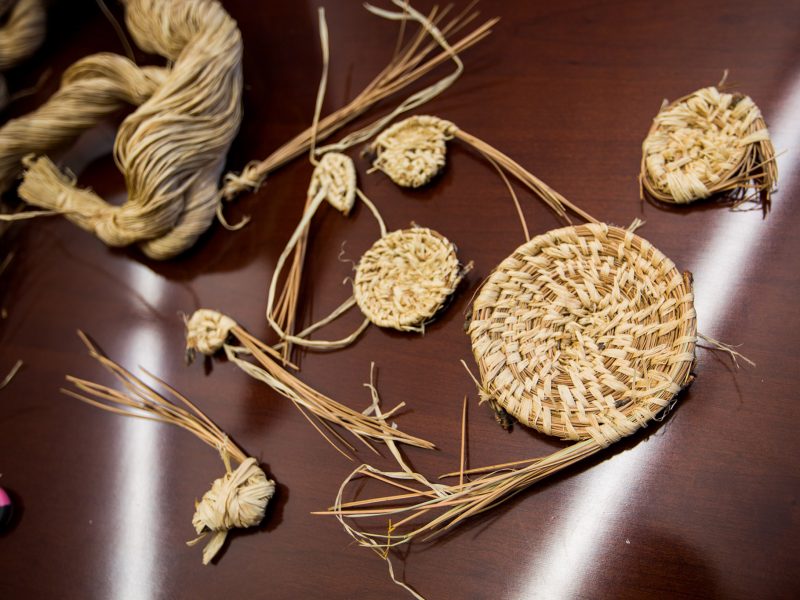 Basket weaving materials on a table.