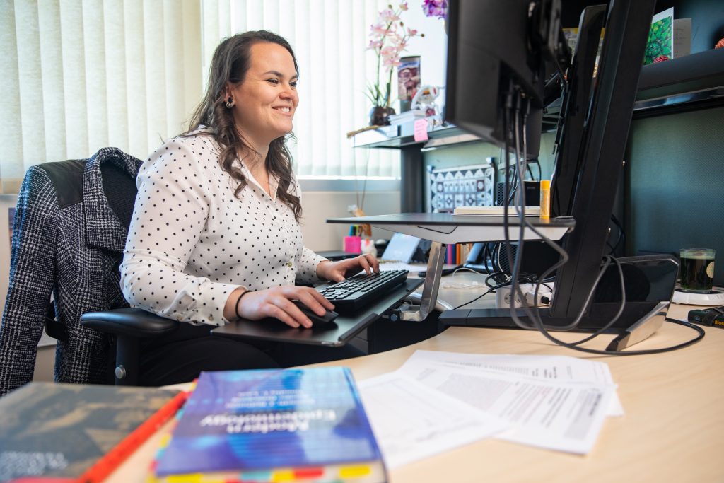 Ricky Camplain working in her office in the N A U Applied Research and Development building.