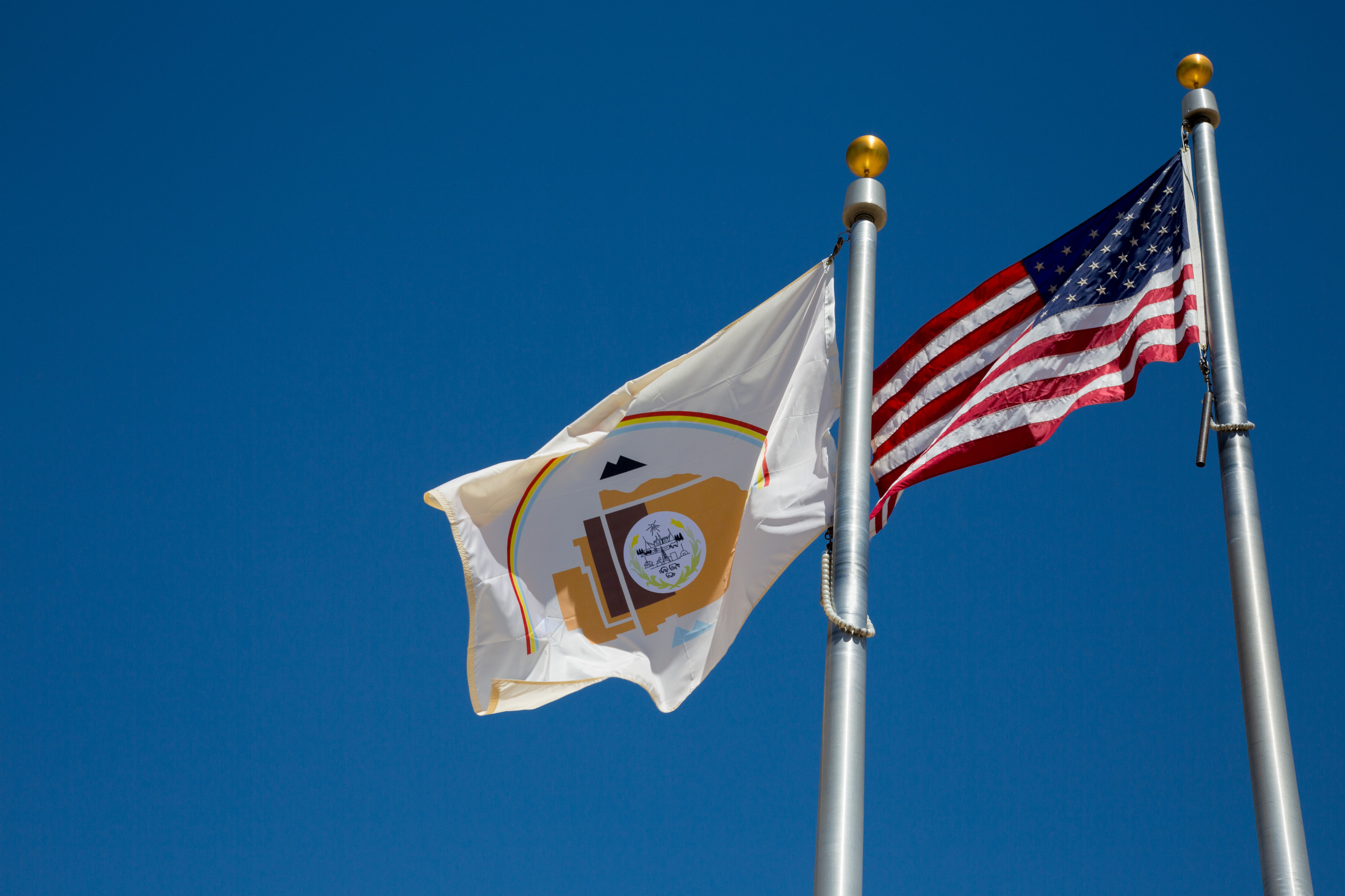 Navajo Nation and American flag flying.