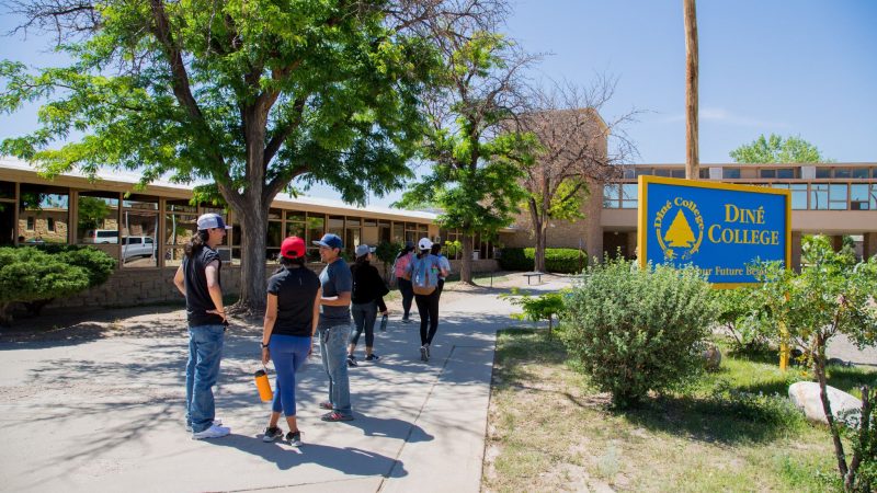 Students standing on the sidewalk at Dine College.