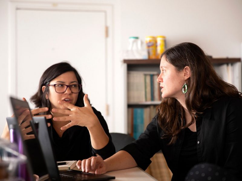 Emery Eaves discusses a project with a team member.