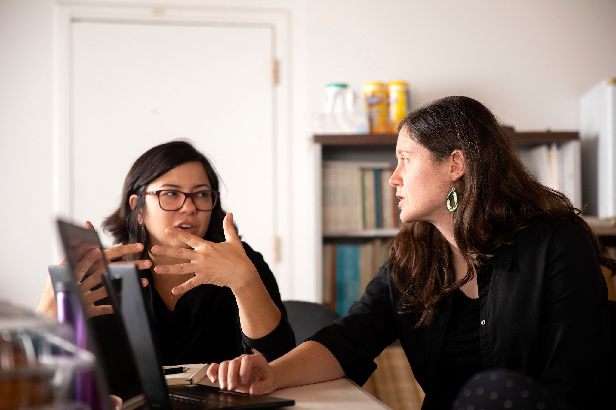 Emery Eaves discusses a project with a team member.