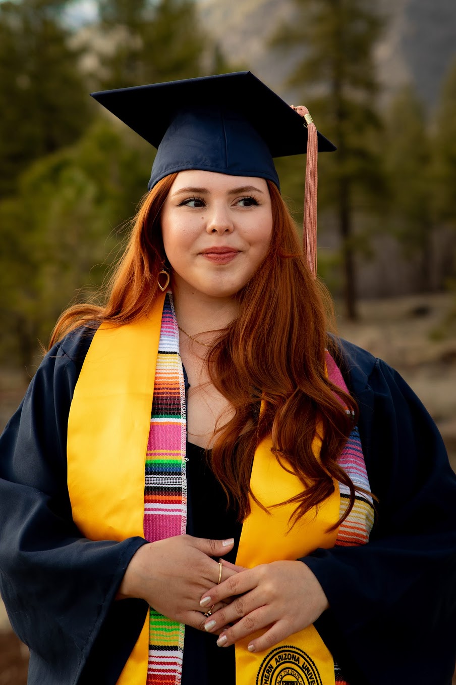 Alexandra Olin smiling in graduate clothes.