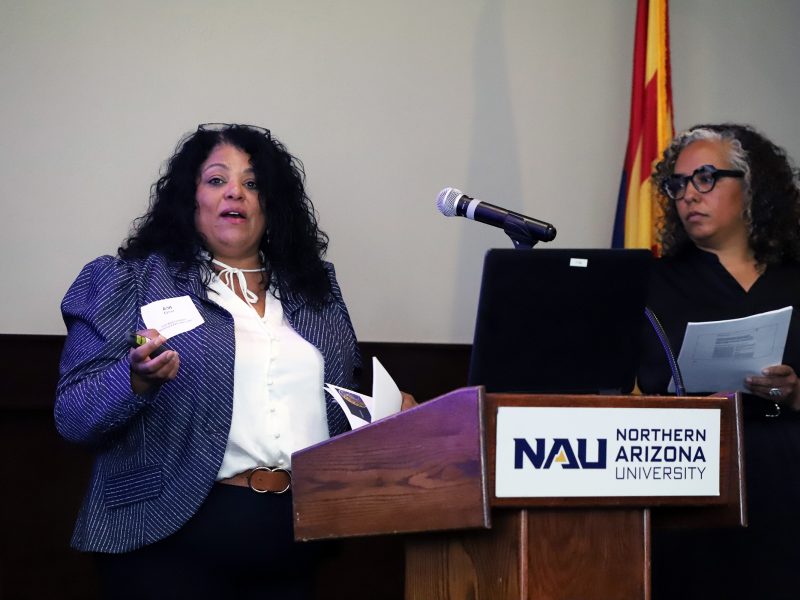 Two Black Lived Experience presenters standing at podium.