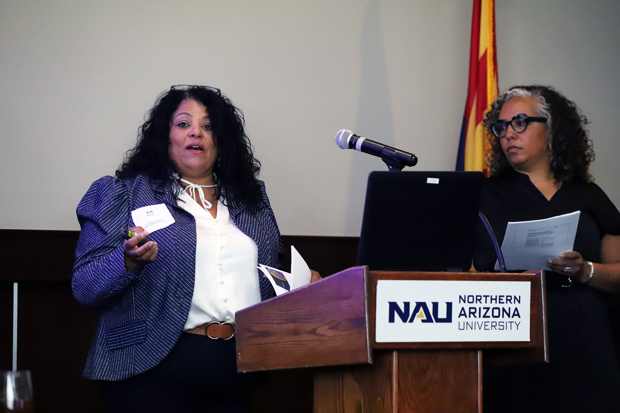 Two Black Lived Experience presenters standing at podium.