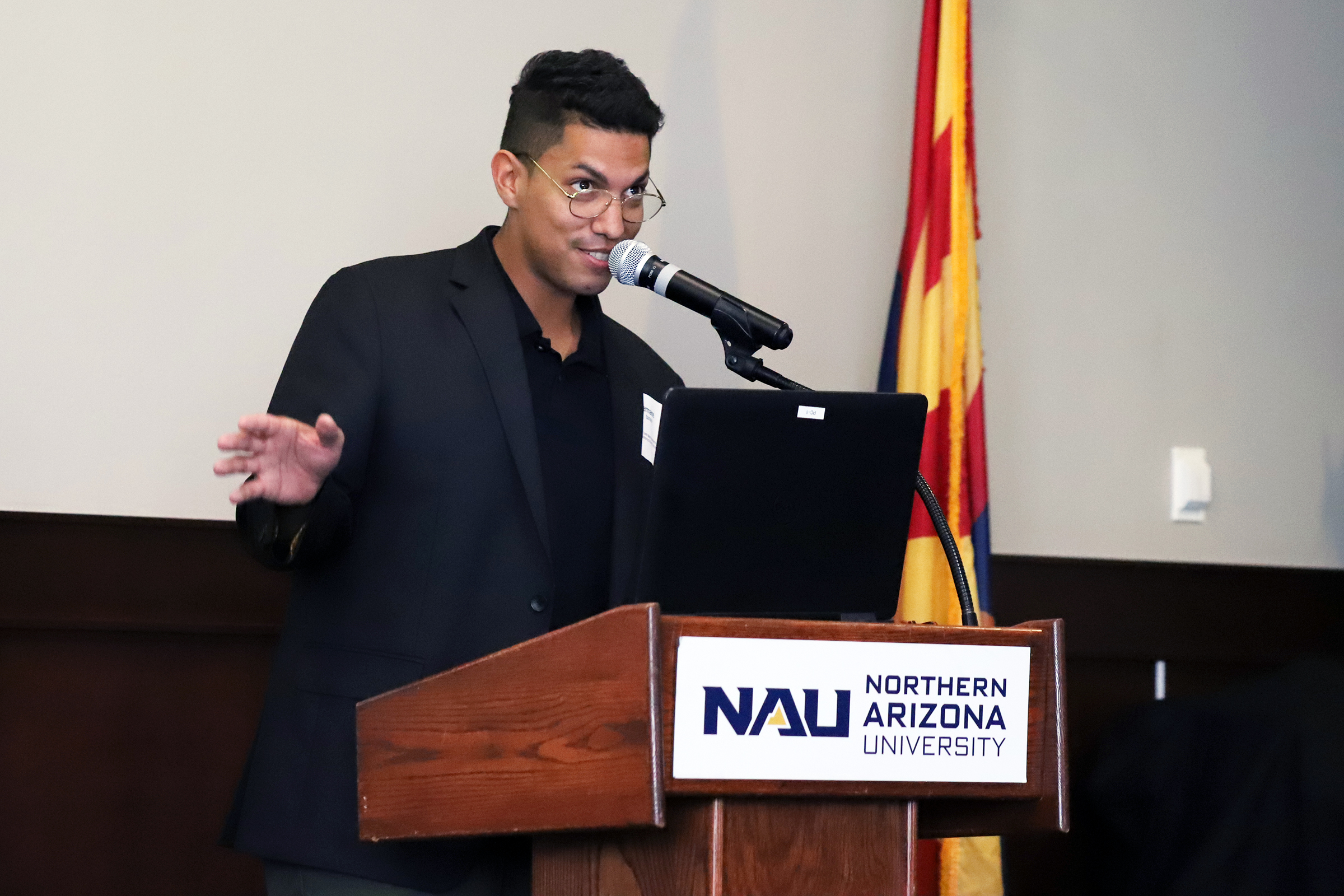 Speaker at podium during Black Lived Experience conference event.