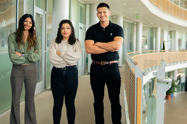 AmeriCorps students from left, Gabriela Monterroza, Alexandrea “Lexa” Ingram and Javier Lopez standing together with their arms crossed.