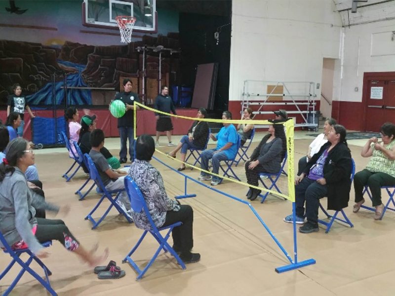 Community members gather to play chair volleyball at the Fitness Center.