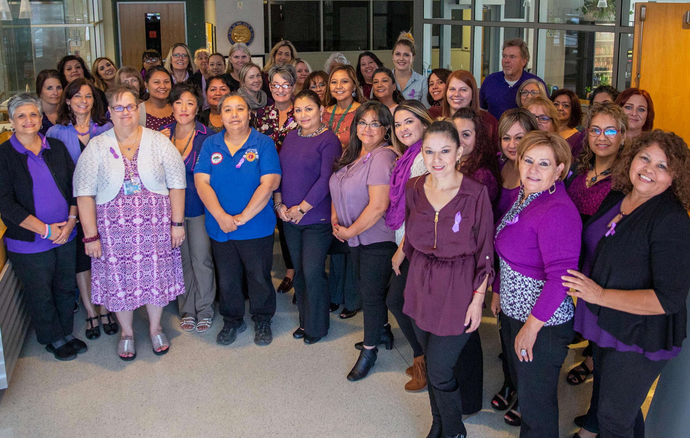 Group of Community Health Workers wearing purple.