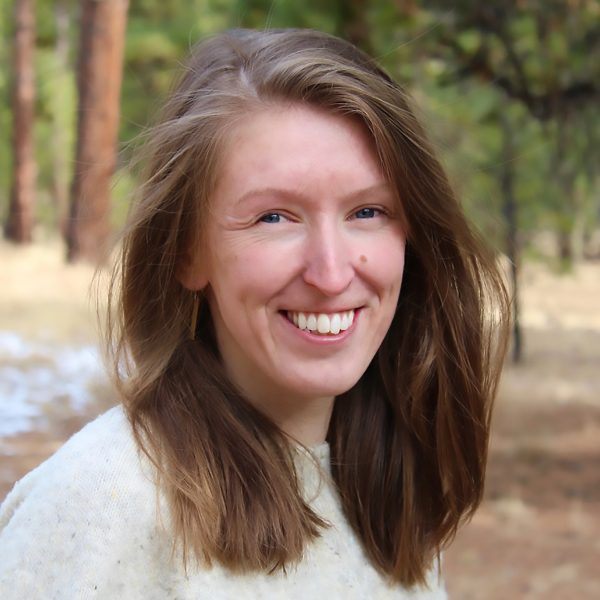 Catrin Edgeley wearing a white sweater, smiling.