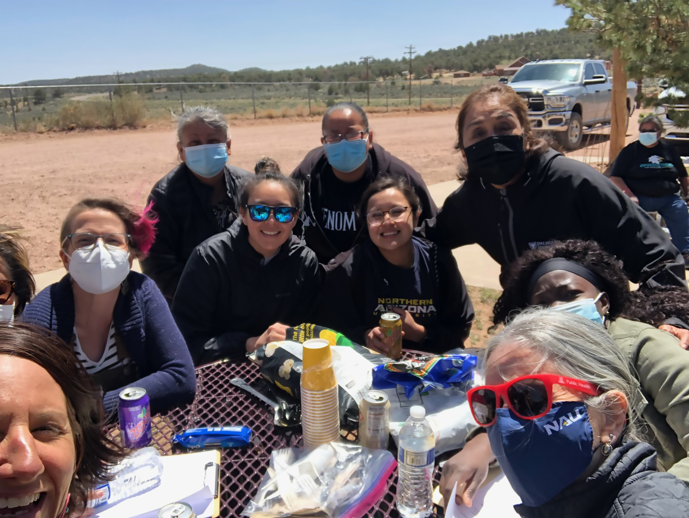 Group of Native Americans posing for a picture around a table.