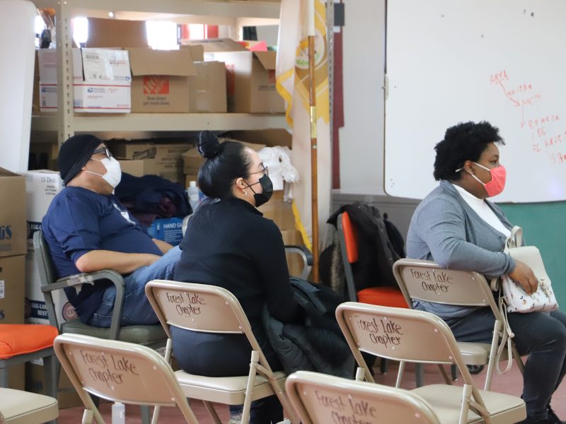 People sitting in chairs at Forest Lake chapter house.