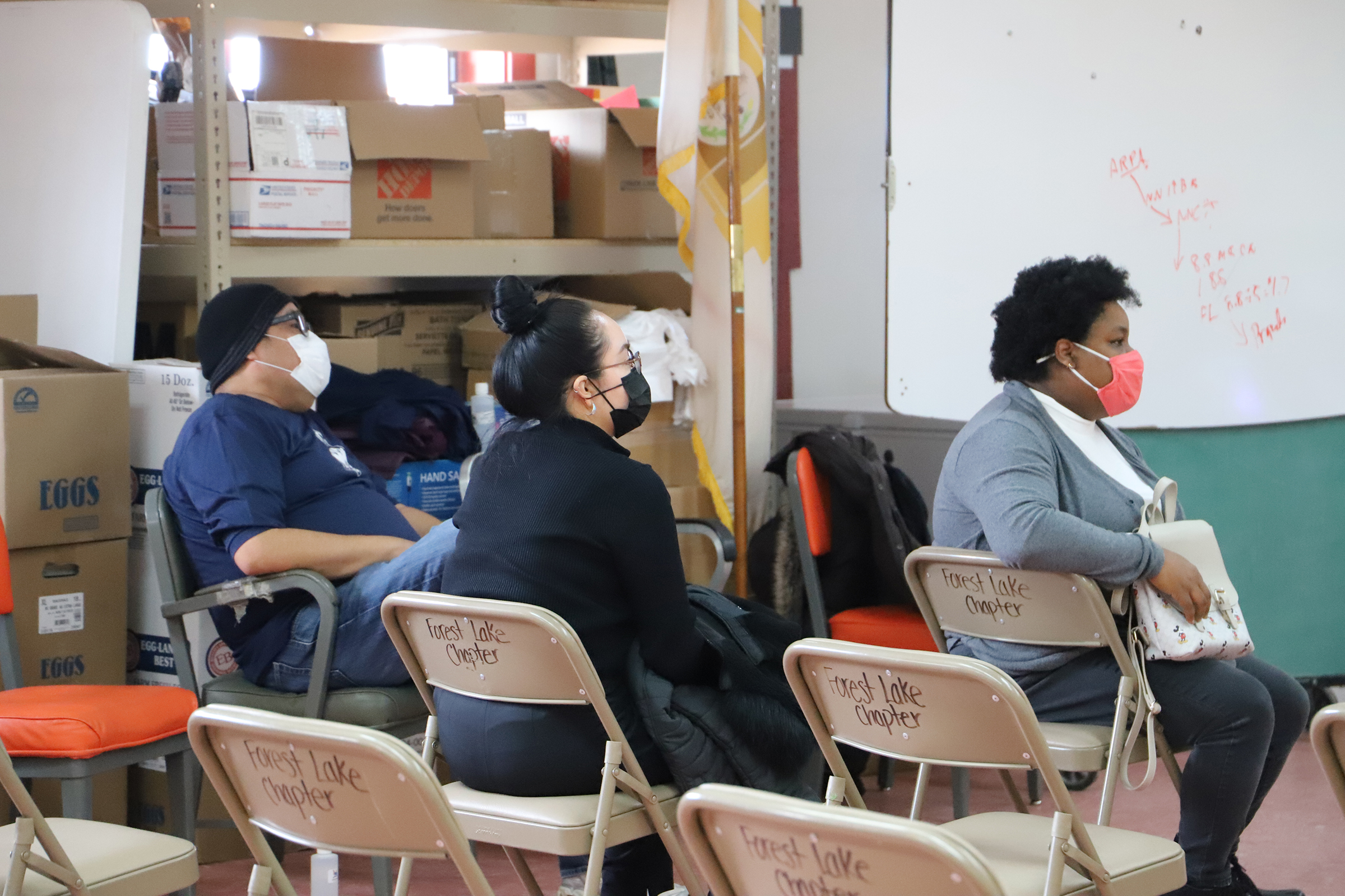 People sitting in chairs at Forest Lake chapter house.