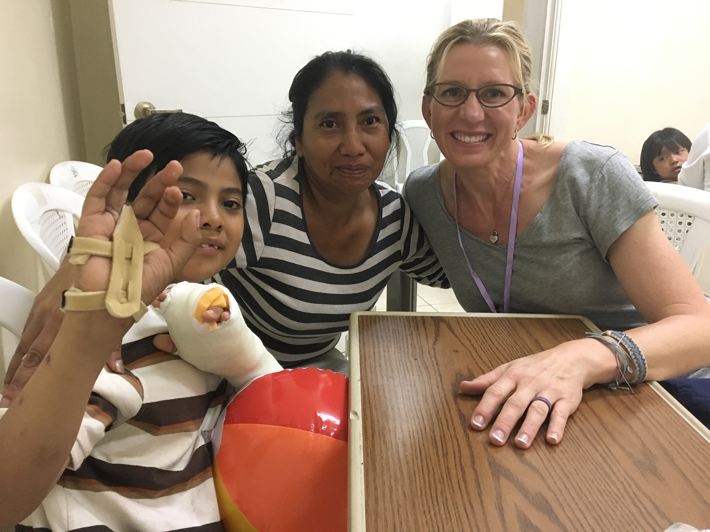 Gretchen Bachman smiling with patients during medical mission to Guatemala.