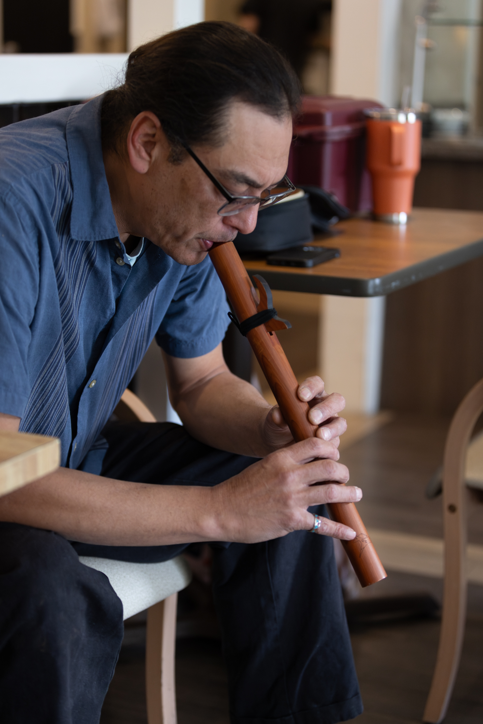 Larry Peterson warms up on his wooden, handmade flute.