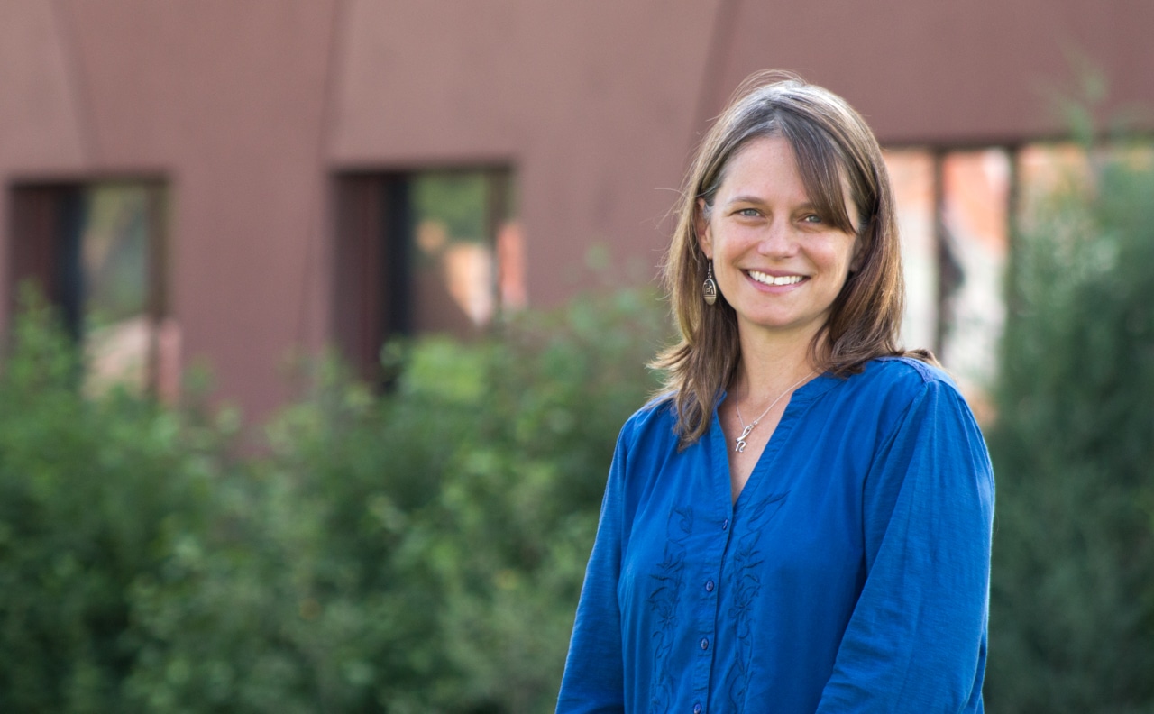 Haeather Williamson wearing a blue shirt and standing outside of the Native American Cultural Center.