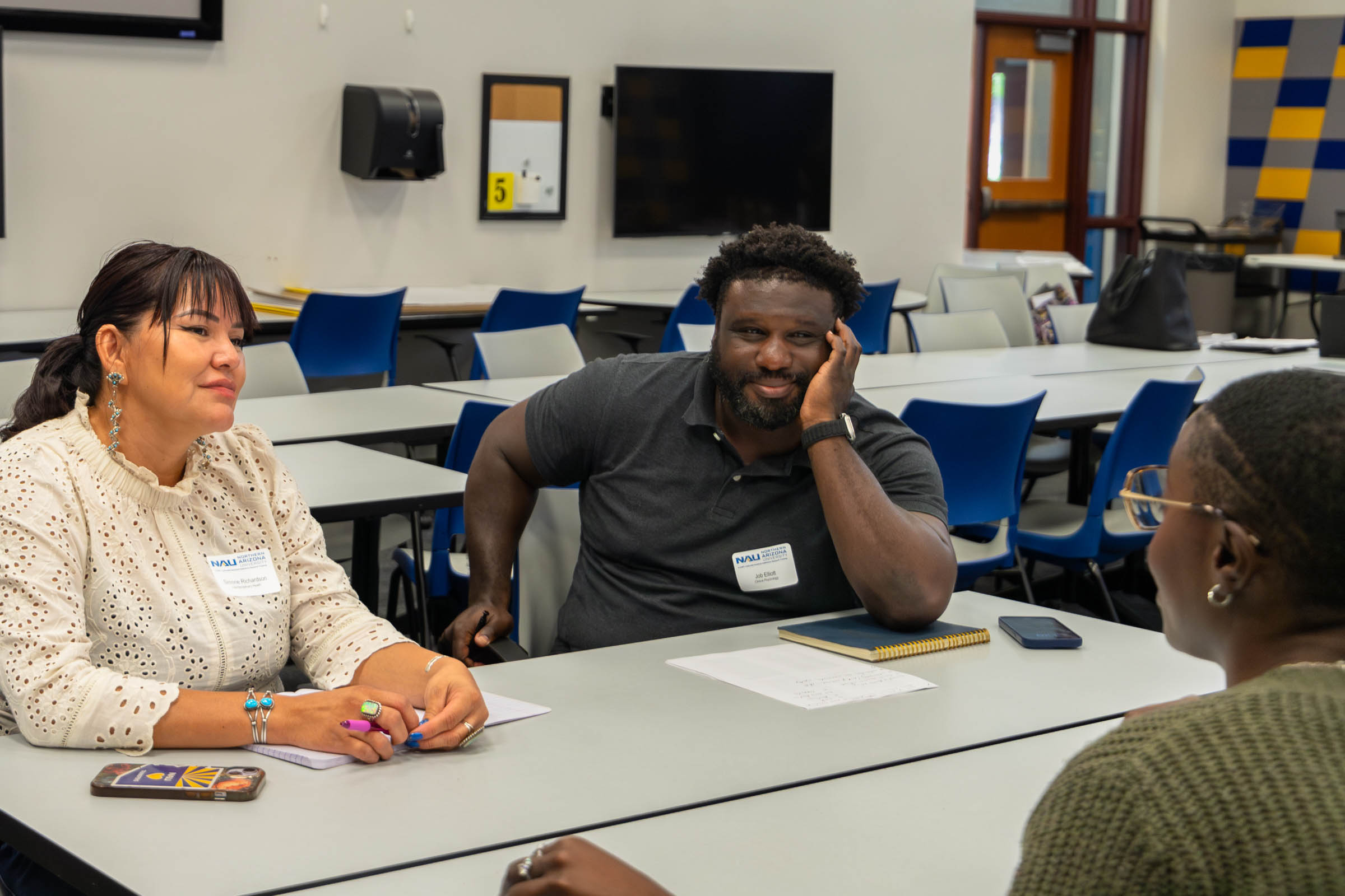 Simone Richardson and Job Elliott (left) speak to Kiera Butler (right) about research interest overlap.