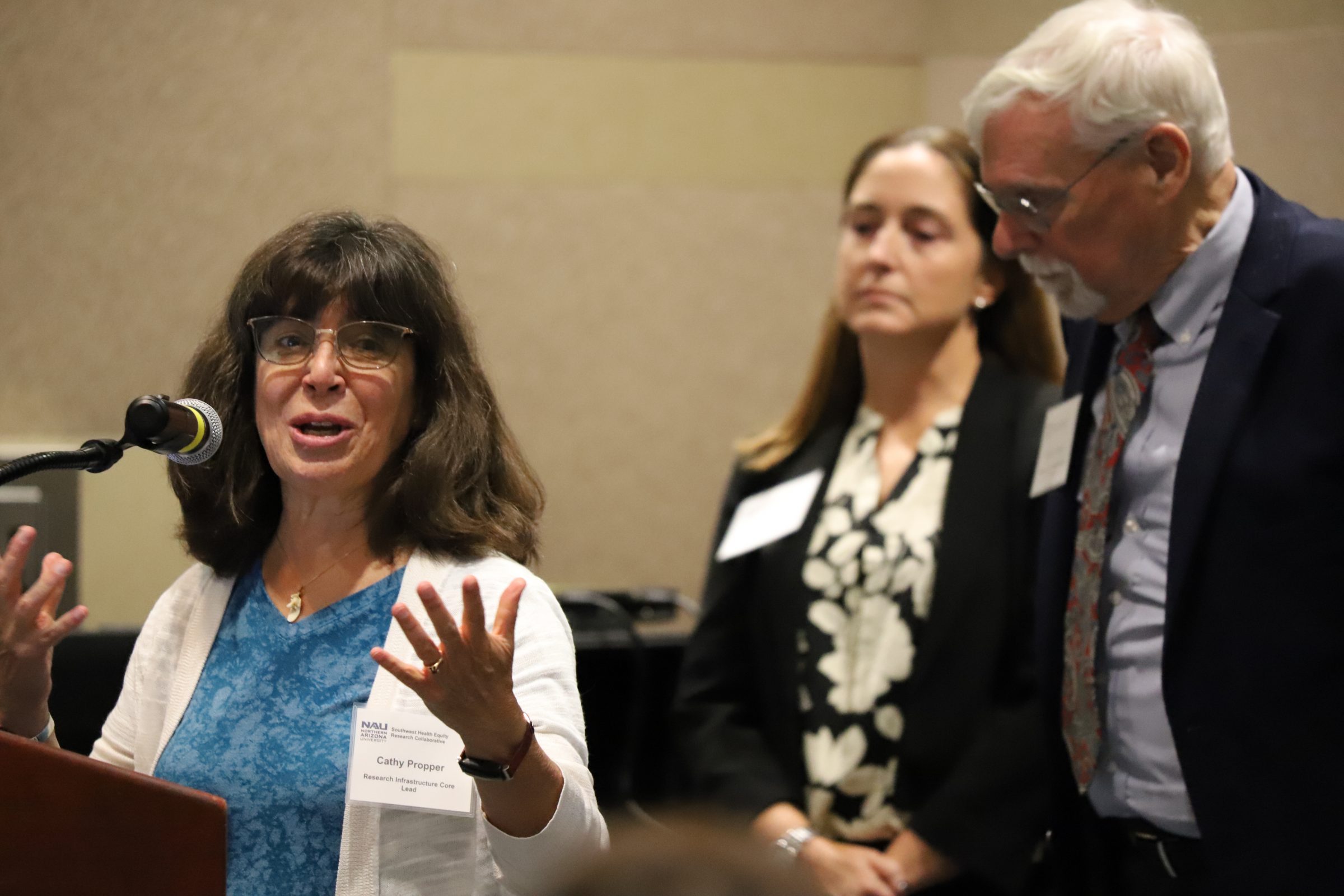 Catherine Propper, Monica Lininger and Robert Trotter II presenting at a meeting.