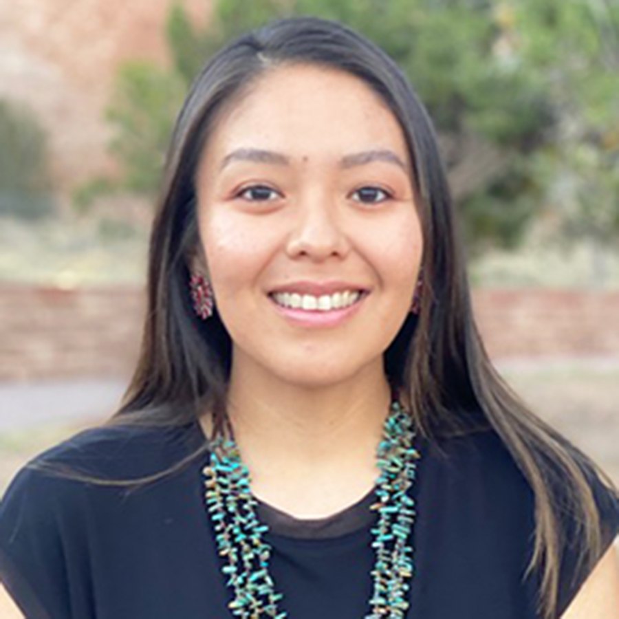 Jayme Biakeddy portrait wearing a black shirt and wearing Native American jewelry.