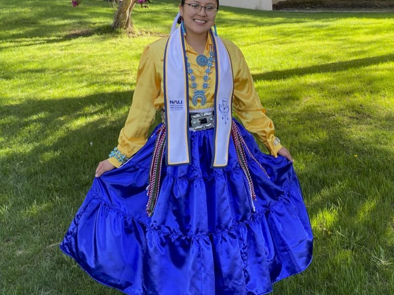 Jennifer Hudson wearing traditional dress on a grassy field.