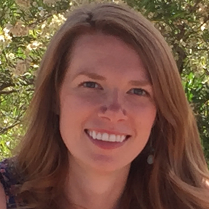 Julia Gardner portrait with trees in the background.