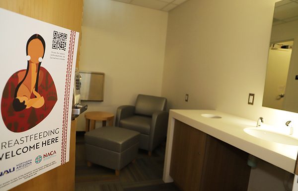 Lactation room with the door open, showing a table and chair inside.