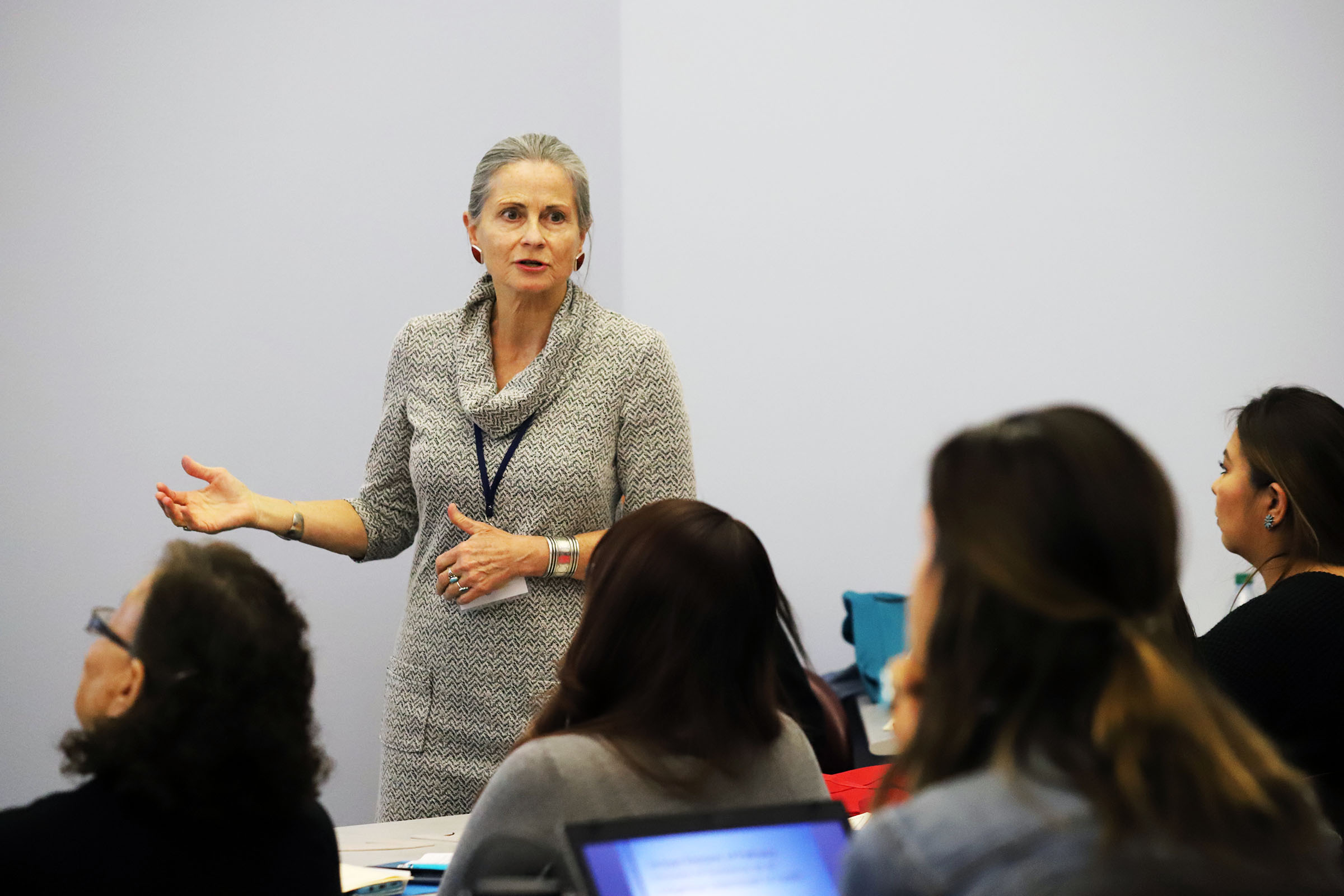 Nicolette-Teufel-Shone in front of a classroom teaching students.