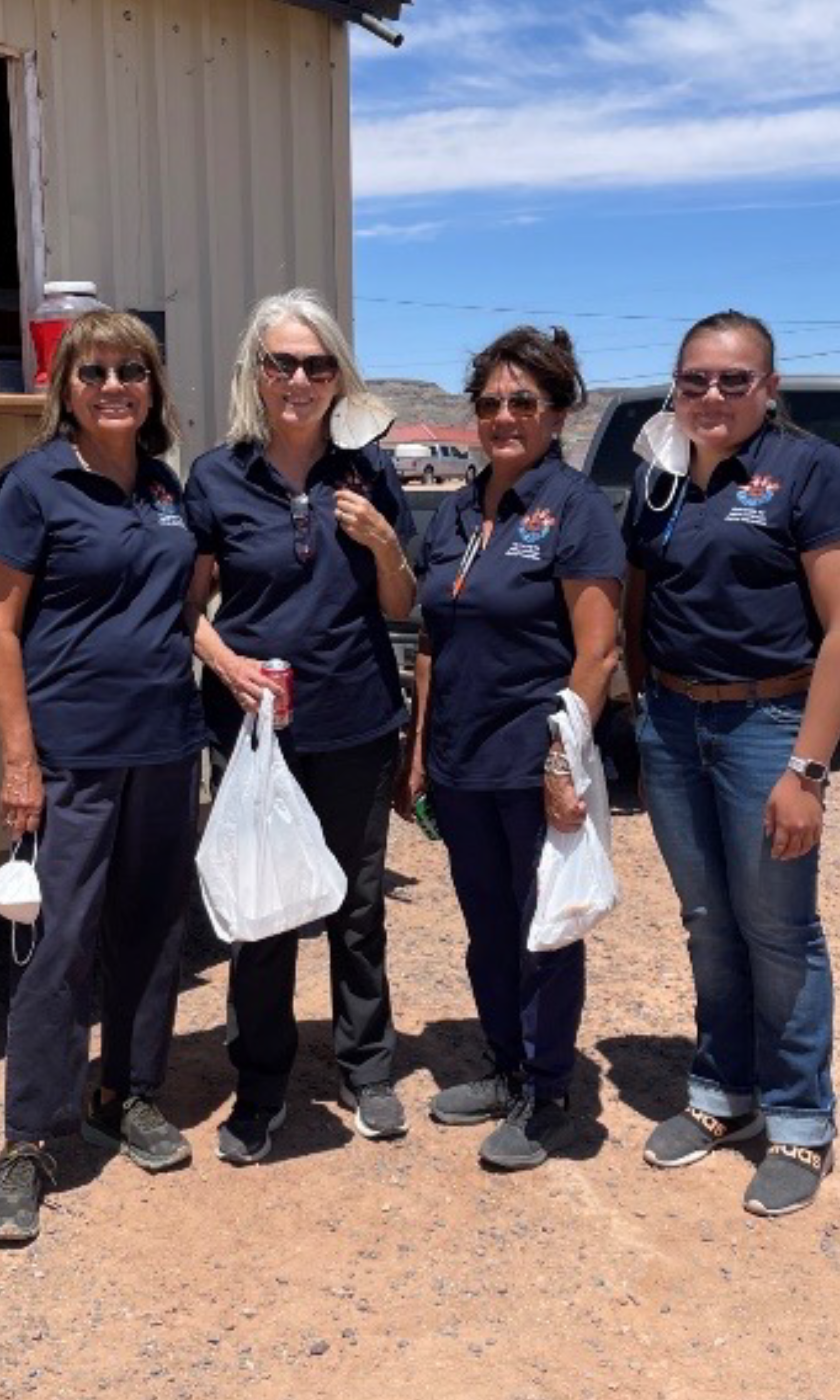 Priscilla Sanderston and three other members of the Navajo Healthy stomach program pose with bags of lunch.