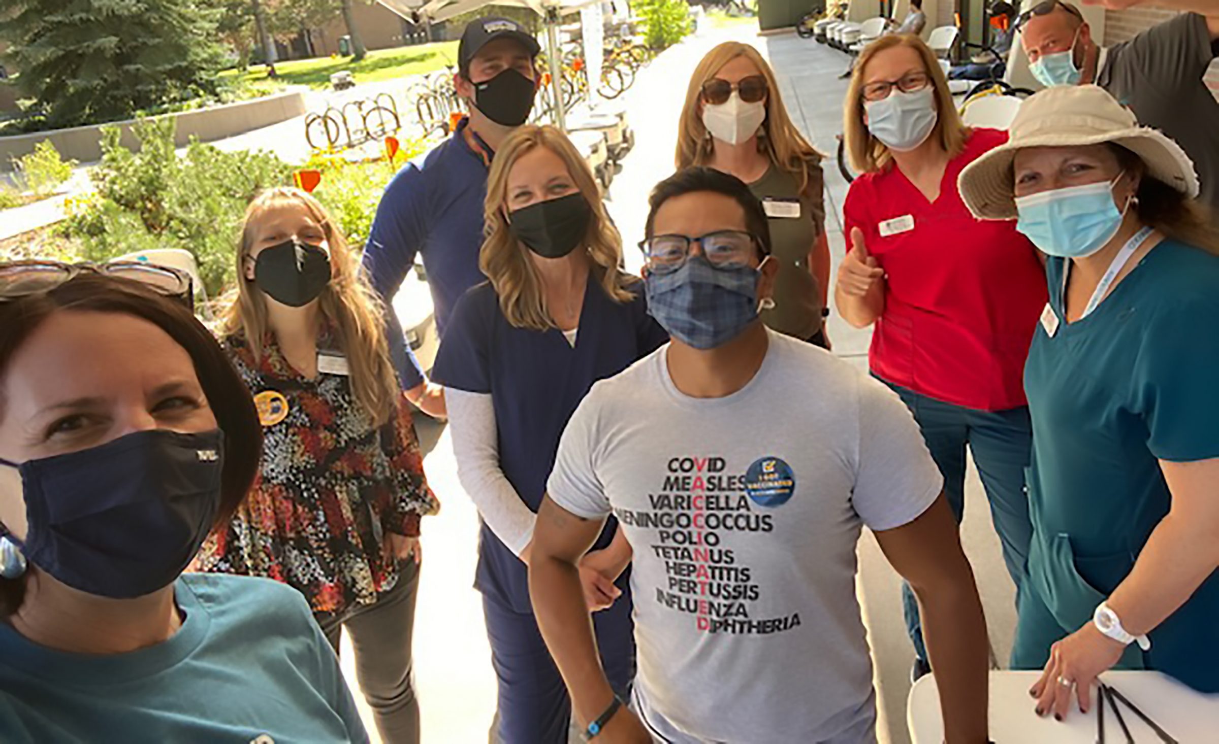 Samantha Sabo and staff wearing masks at event.