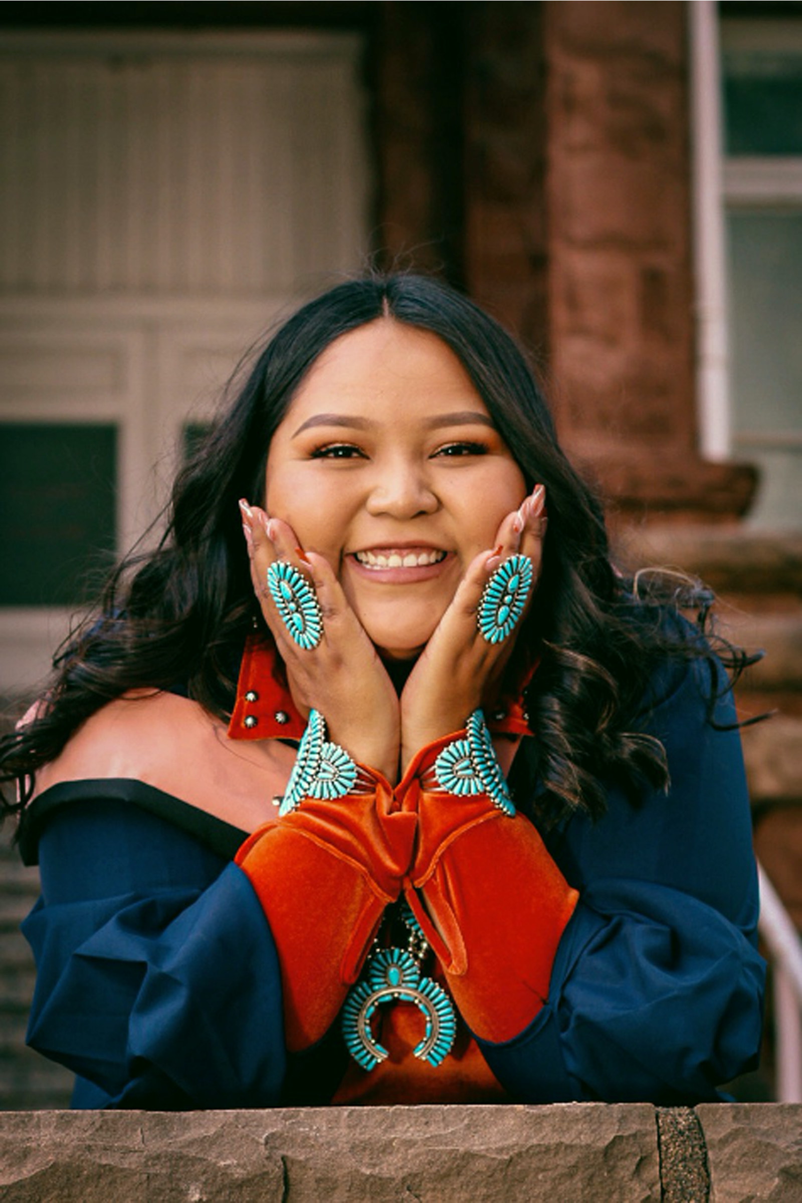 Shawndee George wearing graduation gown and Native American Jewelry.