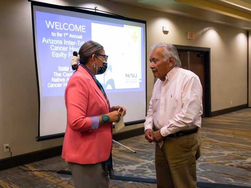 Two AICHEF participants gather to speak to each other on the topics they heard.