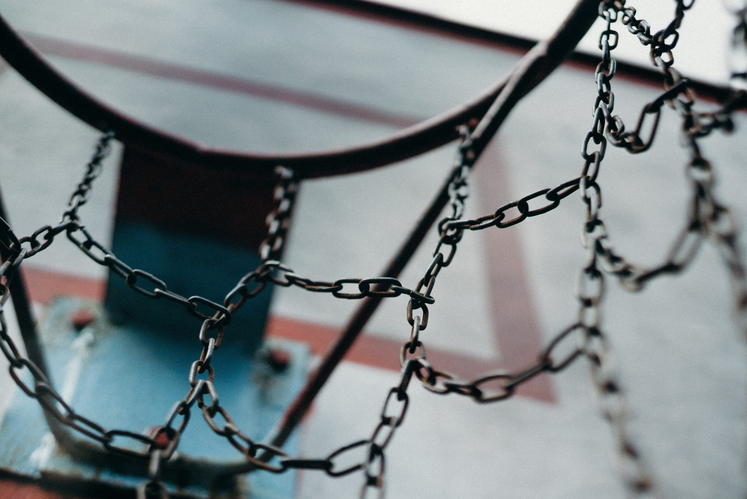 View from within a basketball hoop net looking out at gym.