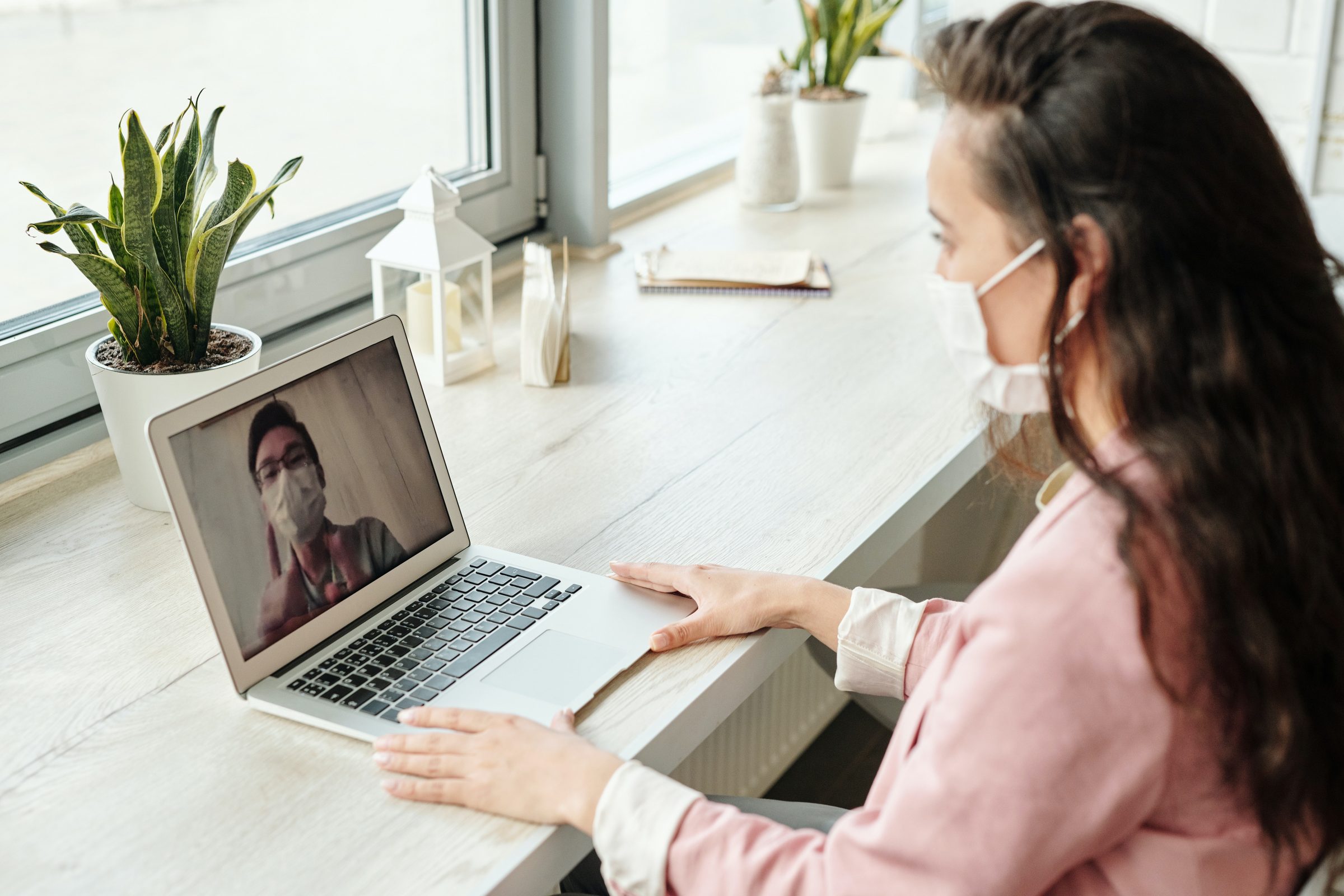 Woman attends telehealth meeting on laptop with doctor.