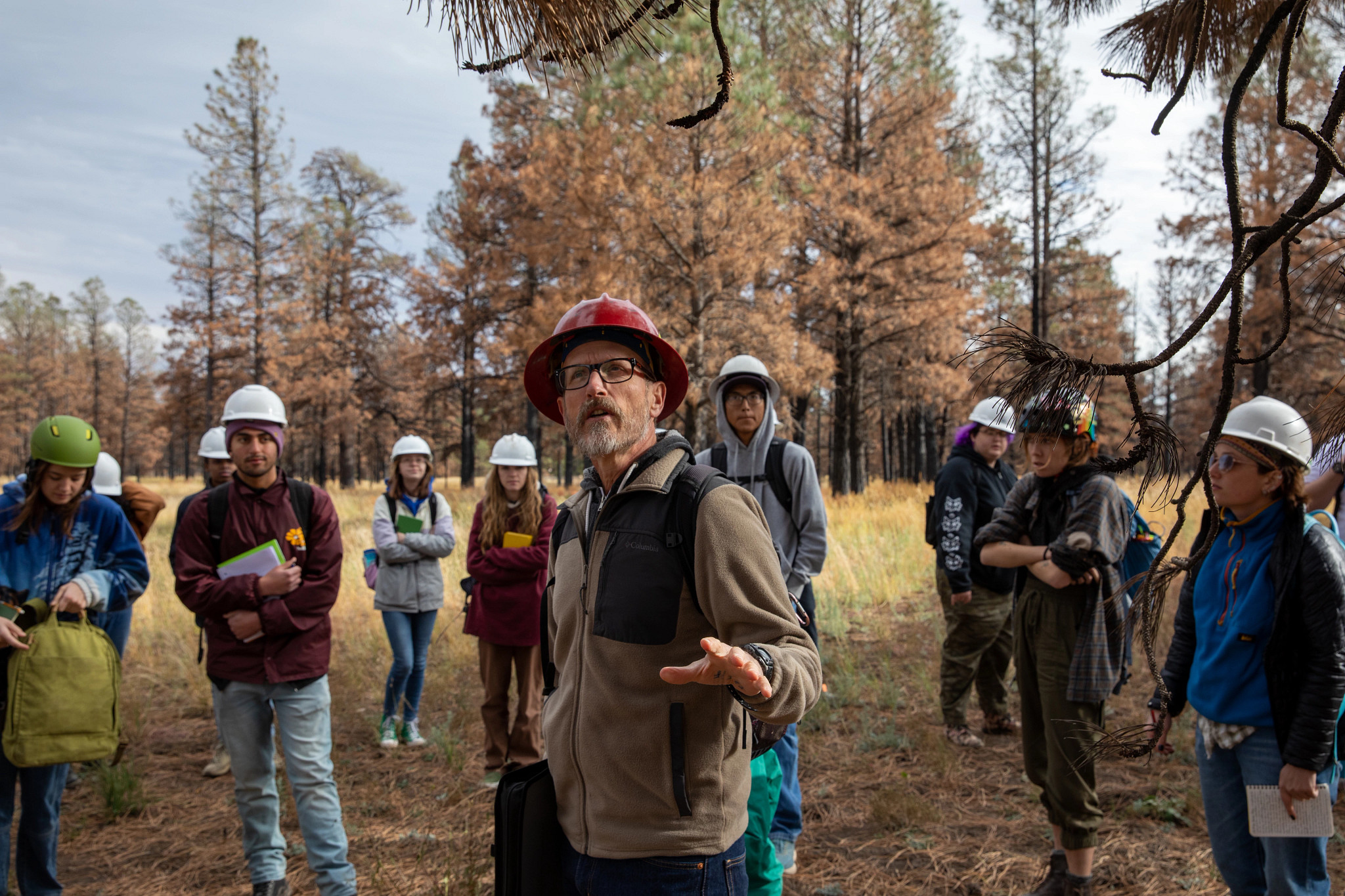 Professor peter fule lecturing to his students while on an outside exhibition.