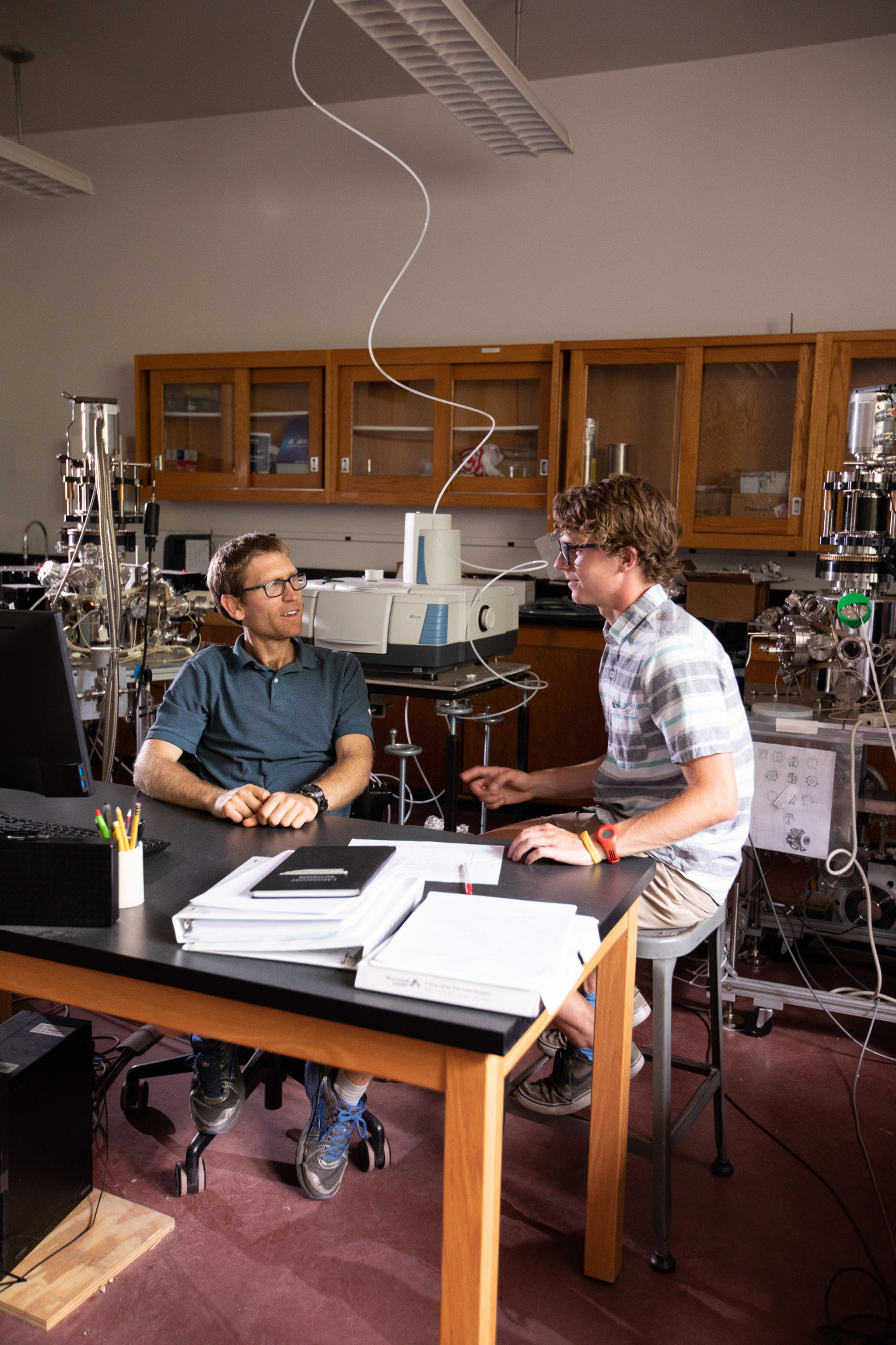 Professor mark loeffler and a student talking.