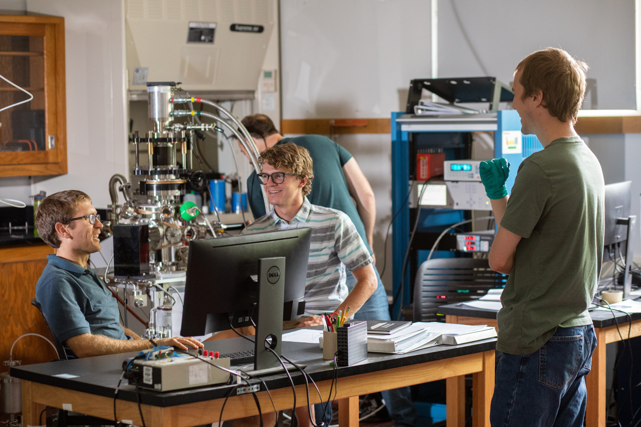 Professor mark loeffler and two students talking.