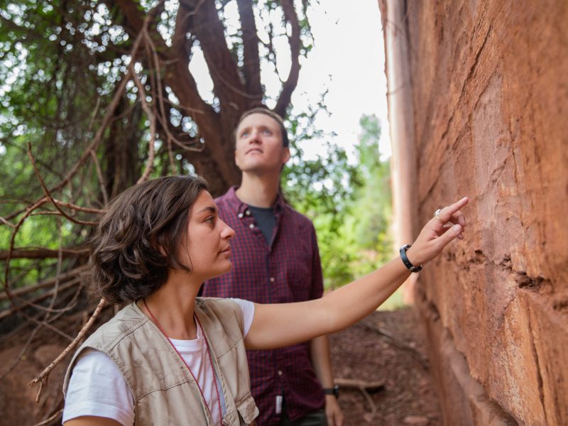 Two students examining a rock.