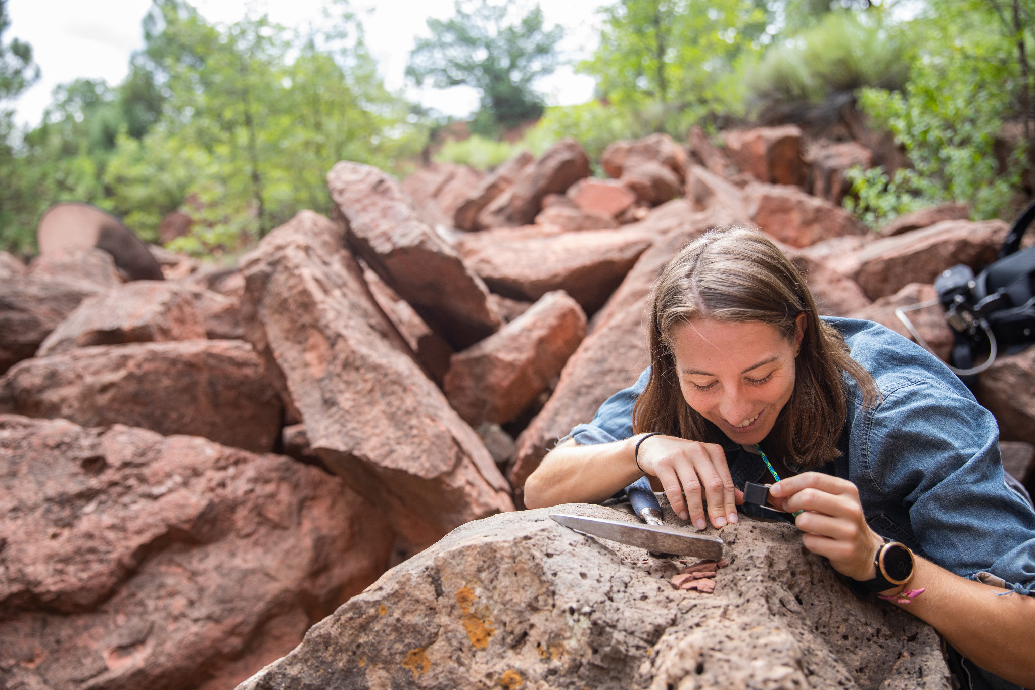 Student looking closely at a rock.