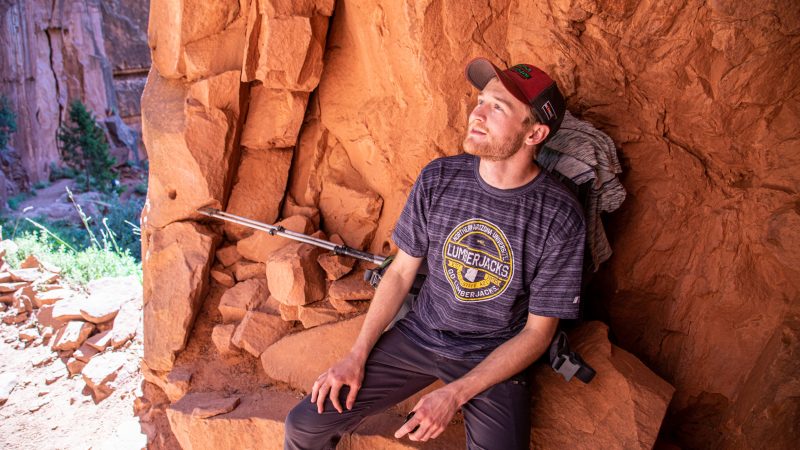 A student sitting on a rock at the Grand Canyon.