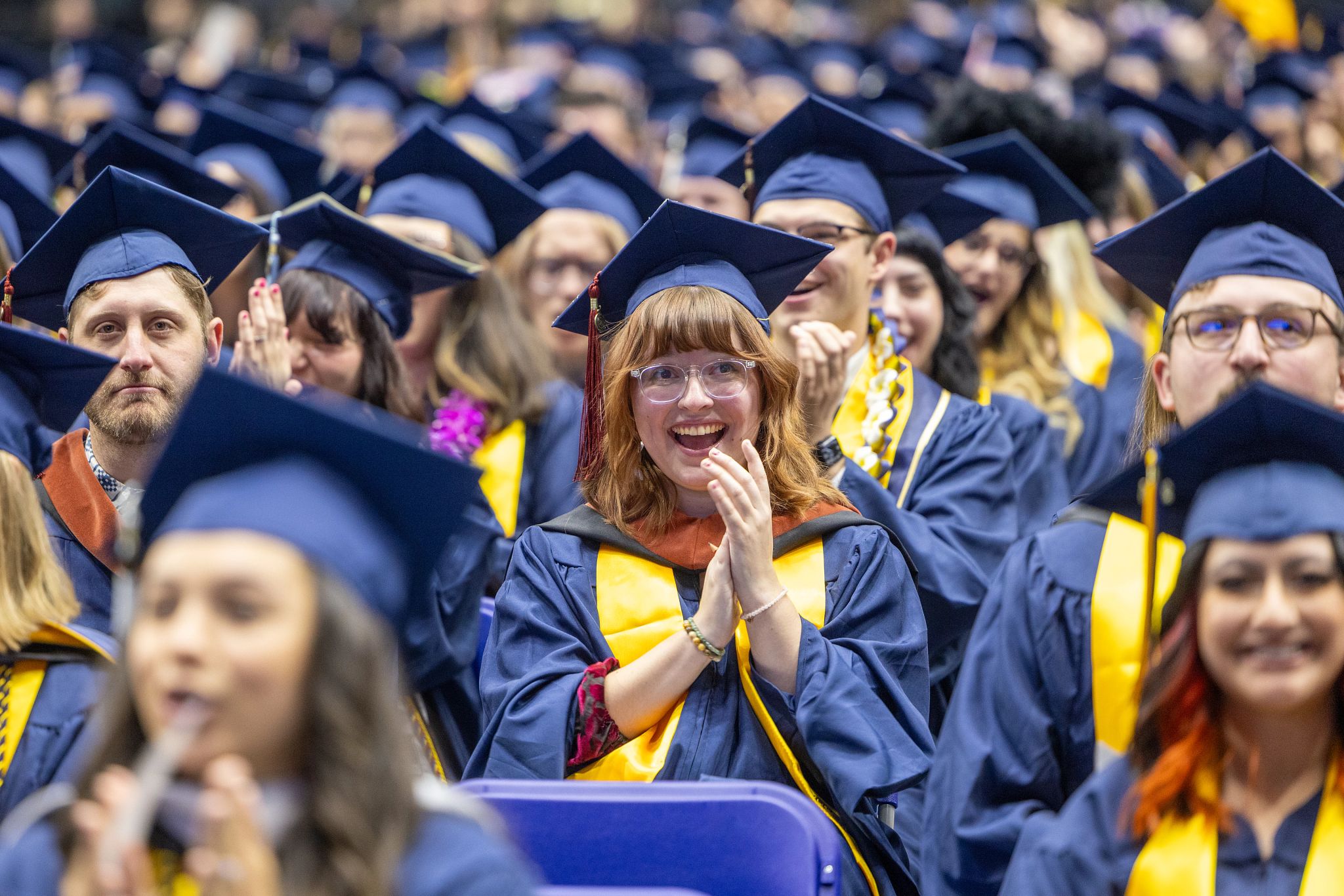 Students clapping at their graduation ceremony