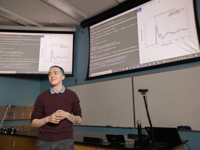 A student presenting in front of an audience.