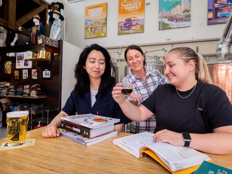 Students with books and beer at the Tap Room.